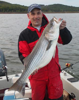 Chris with his 25lb striper, they fished with Norfork lake guide service STR Outfitters