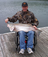 Gregg with his 27 lb striper caught with Lake Norfork guide STR Outfitters May. 2011