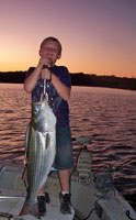 Isaac with his 18 lb striper caught with Tom Reynolds Norfork stripers & STR Outfitters