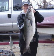 Mary holding a 27 lb striper caught with Lake Norfork Guide Tom Reynolds