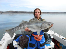 Micki with her 22 lb striper she fished with STR Outfitters