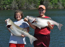 Anna & Lance with 19 & 22 lb stripers, they fished with Norfork lake guide service STR Outfitters
