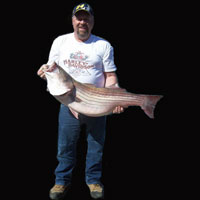 Kenny with a 32 lb striper caught with Lake Norfork guide STR Outfitters march 09